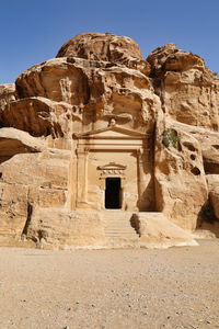 House carved in the sandstone rock near east entrance of little petra, jordan