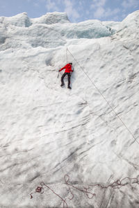 Rear view of man climbing haugabreen glacier