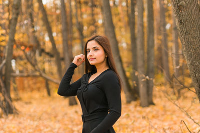 Young woman standing in forest