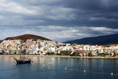 Boat on sea against cloudy sky