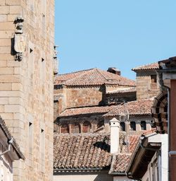 Low angle view of buildings against blue sky