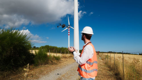 Engineer is using a drone in a wind field