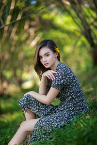 Portrait of young woman sitting outdoors