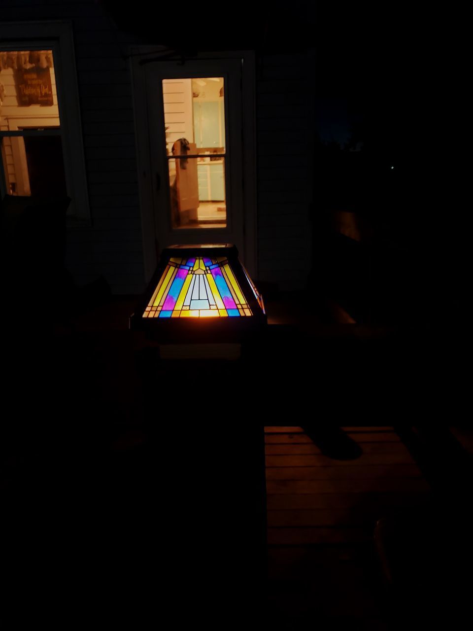 ILLUMINATED BUILDING SEEN THROUGH WINDOW