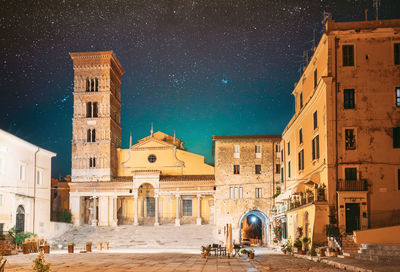 Low angle view of buildings in city at night