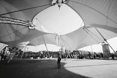 Man standing under tent 