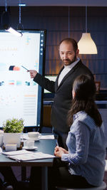 Businessman giving presentation at office