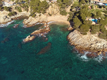 High angle view of rocks by sea