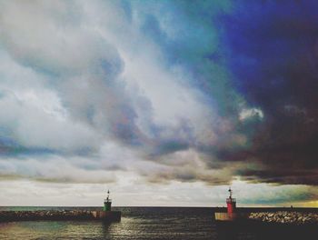 Scenic view of rainbow over sea against sky