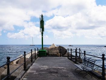 Pier over sea against sky