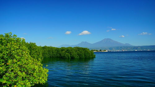 Scenic view of mountains against blue sky