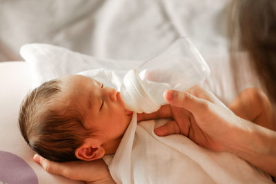 Close-up of baby sleeping on bed