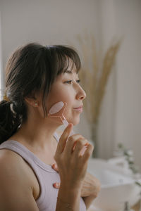 Portrait of woman looking away at home