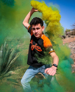 Portrait of young man holding camera