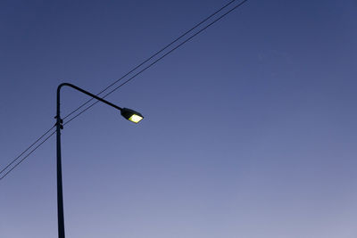 Low angle view of street light against clear blue sky