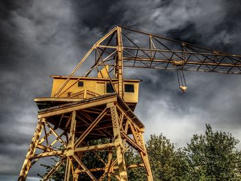 Low angle view of crane against sky