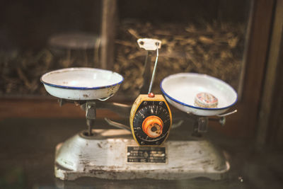 Close-up of old weight scale on table