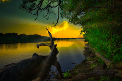 Scenic view of lake against sky during sunset