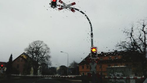 Wet city against sky