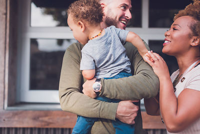 Family of three playing in downtown, son is looking away