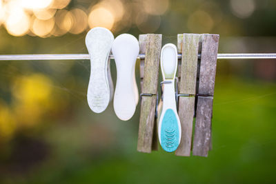 Close-up of clothespins hanging on rope