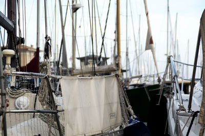 Sailboats moored in sea against sky