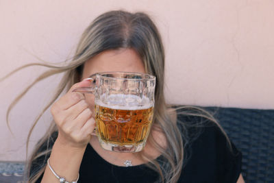 Mature woman looking through beer glass