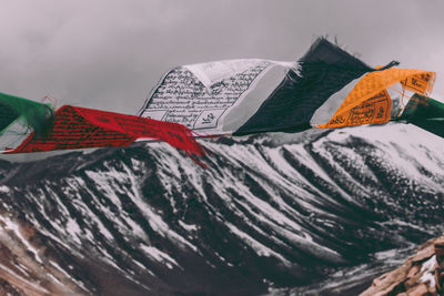 Low angle view of flags against sky