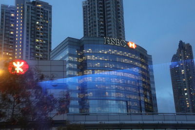 Low angle view of illuminated skyscraper against sky at night