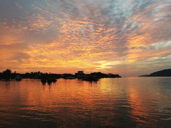 Scenic view of lake against orange sky