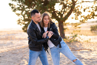 Couple wearing jacket standing outdoors