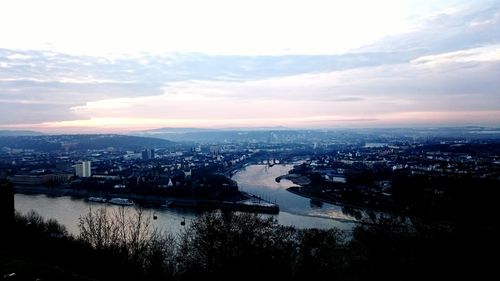 Aerial view of city against sky during sunset