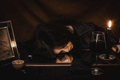 Man drinking glass on table