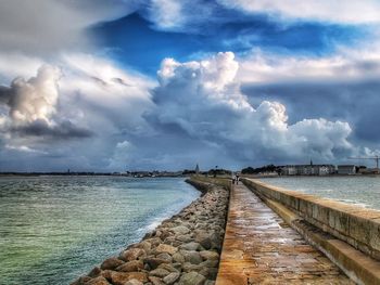 Scenic view of sea against storm clouds