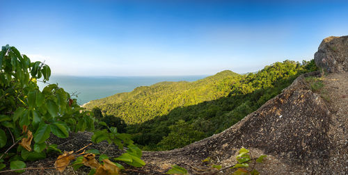 Scenic view of mountain against blue sky