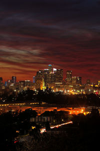 High angle view of illuminated buildings against sky at night