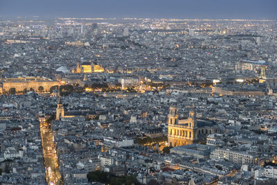 Aerial view of paris at dusk with the city illuminated