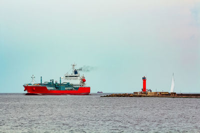 Ship sailing in sea against clear sky