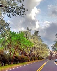 Empty road against cloudy sky