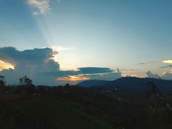 Scenic view of field against sky at sunset