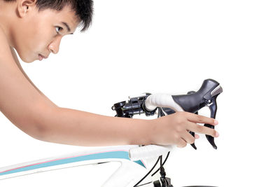 Side view of boy photographing against white background