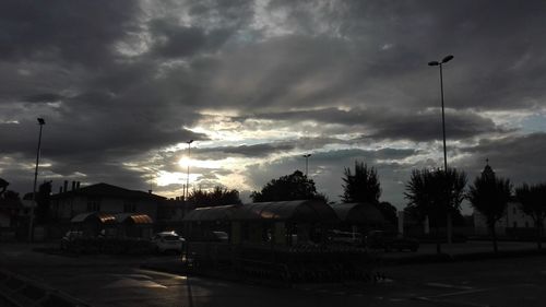 Street light against cloudy sky