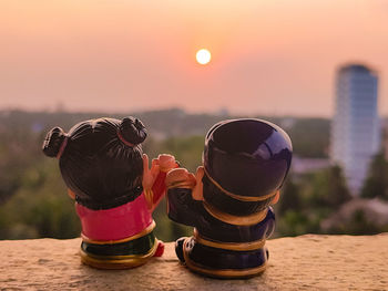 Close-up of drink on table against sky during sunset