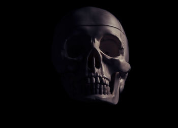Close-up of human hand against black background