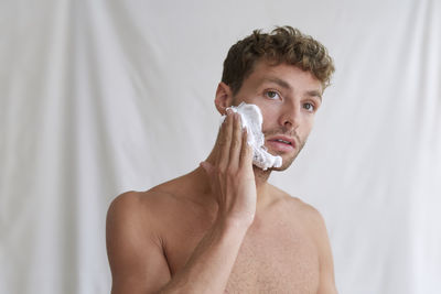 Portrait of handsome young man in bathroom