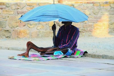 Woman sitting on wet street