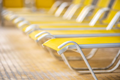 Close-up of yellow chairs in row