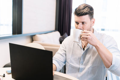 Mid adult man using mobile phone