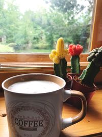 Close-up of flower vase on window sill