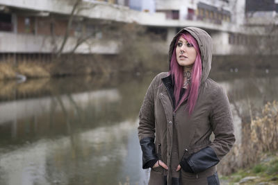 Beautiful woman standing by canal